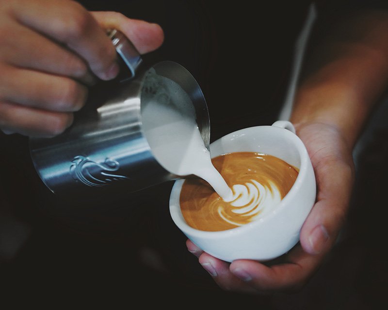 Barista pouring latte art