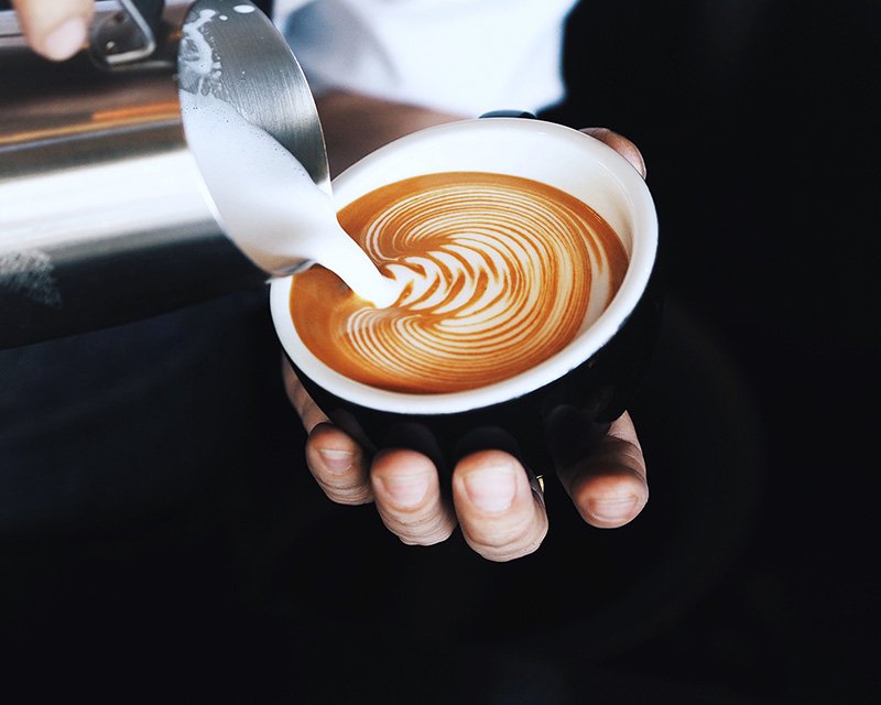 Barista pouring latte art